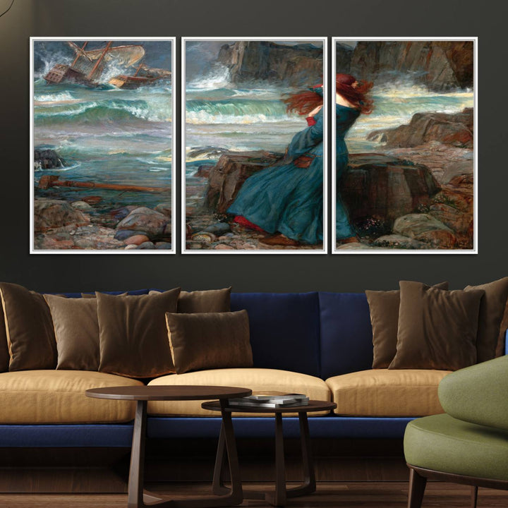 The Miranda by the Shore Wall Art Canvas Print depicts a woman in a blue dress standing by the sea, watching a shipwreck.