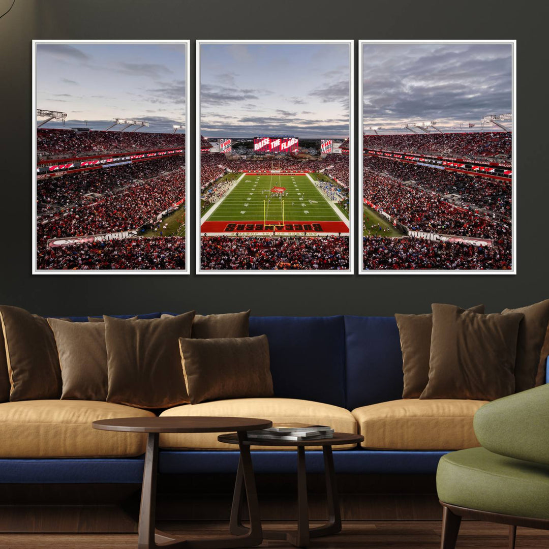 The wall art captures a stunning scene of Raymond James Stadium bathed in the warm hues of sunset. The sky, filled with clouds, provides a dramatic contrast to the vibrant lighting on the field, encapsulating the dynamic energy of a football game.