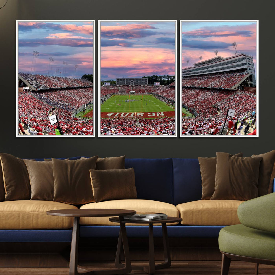 The wall art captures an NC State Wolfpack game under a vibrant sunset on triple canvas.