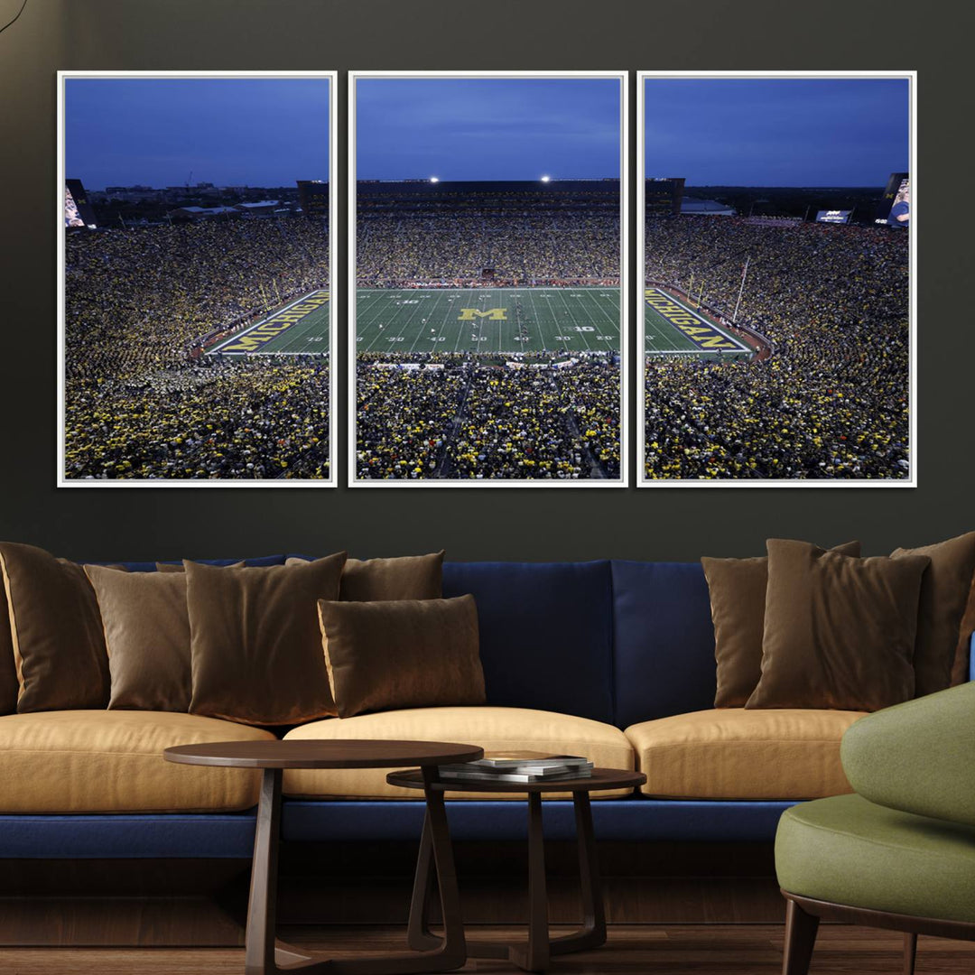 Wall art featuring an aerial shot of Michigan Stadium at dusk, showcasing the University of Michigan Wolverines M logo.