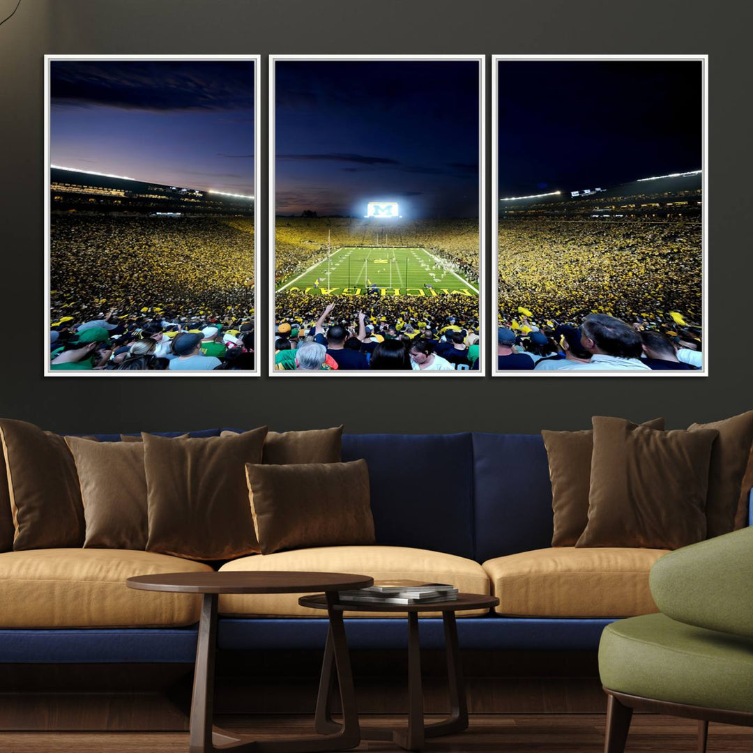 The wall art features a glowing M in this Michigan Wolverines Football Team Ann Arbor Stadium Canvas Print.