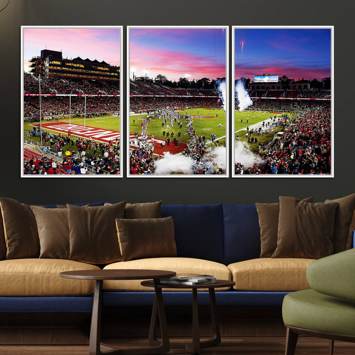 The wall art features a canvas print of the Stanford Cardinal football team, capturing players, fireworks, and smoke against the backdrop of a sunset at Stanford Stadium.