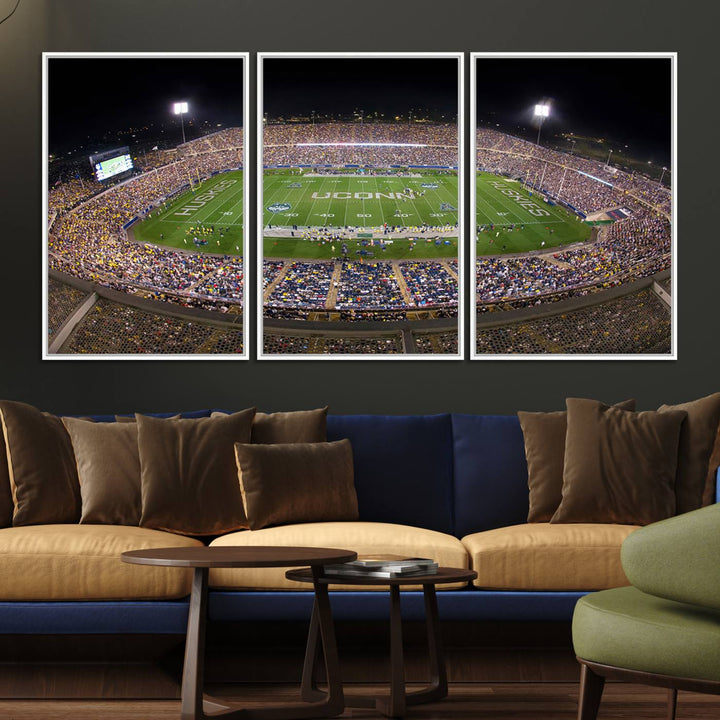 A large football stadium at night, featuring the UCONN Huskies, is depicted on the East Hartford Pratt & Whitney Stadium Wall Art Canvas Print.