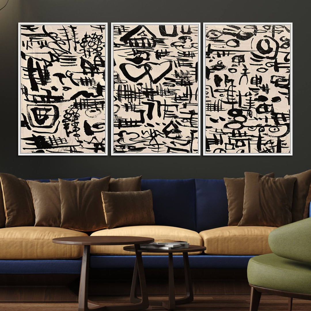 The Abstract Love and Chaos canvas is a museum-quality print featuring black symbols on a beige background, adorned with a heart and scribble design. It is framed to enhance its artistic appeal.