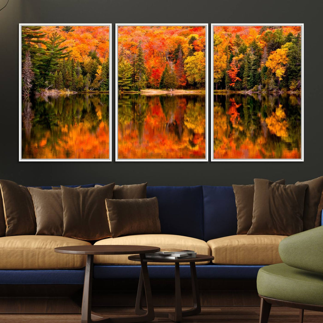 Autumn Forest Reflection Wall Art: a vibrant triptych canvas featuring fall foliage with red, orange, and yellow leaves over a calm lake.