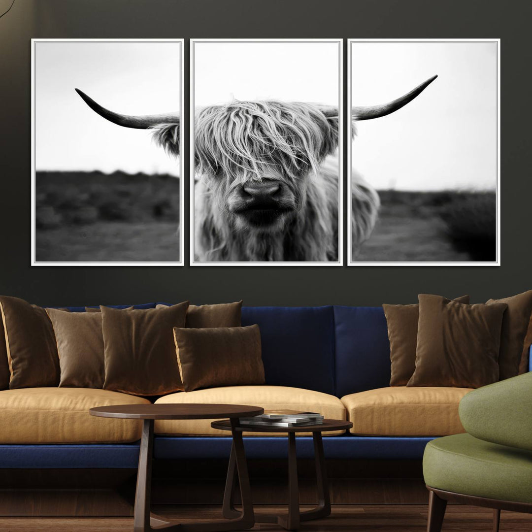 The Highland Cow Wall Art, a black and white farmhouse decor piece showcased as a triptych canvas print, graces a dark wall with its long-haired Scottish Highland cattle art print exuding rustic barn aesthetic.