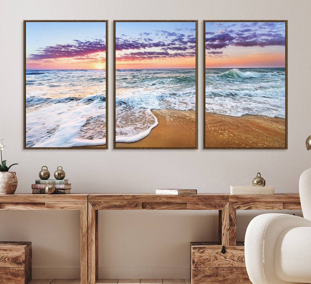 The Coastal Sunset Art Canvas Print features ocean waves beneath a vibrant sky in a stunning 3-panel seascape.