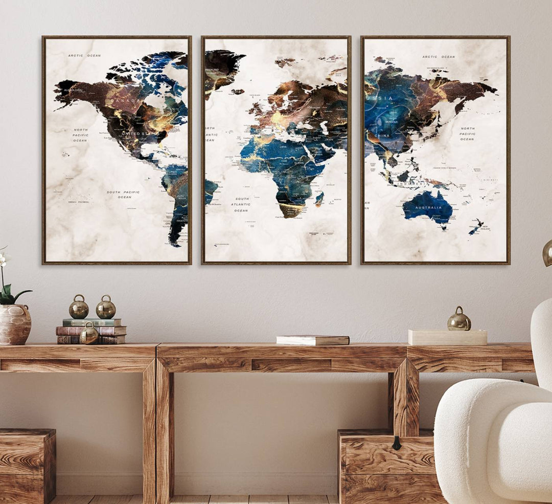 Abstract earth-toned 3-panel world map wall art featuring blues and browns, ready to hang; it showcases continents on modern canvas.