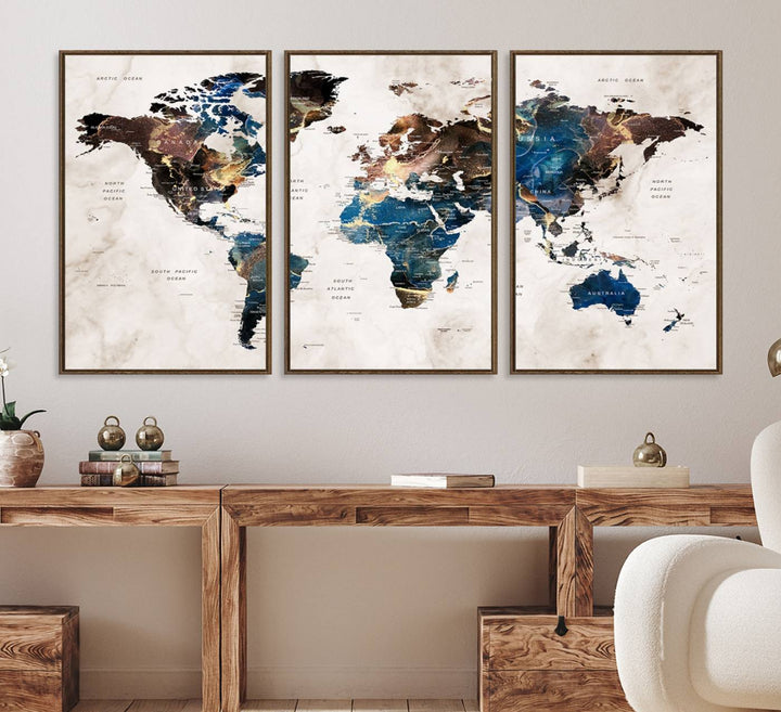 Abstract earth-toned 3-panel world map wall art featuring blues and browns, ready to hang; it showcases continents on modern canvas.