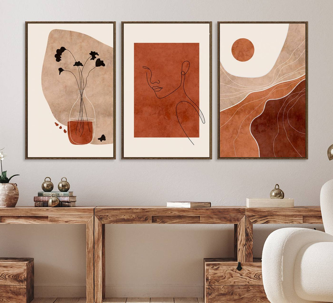 A giclée canvas triptych showcases minimalist mountain landscapes in earthy tones.