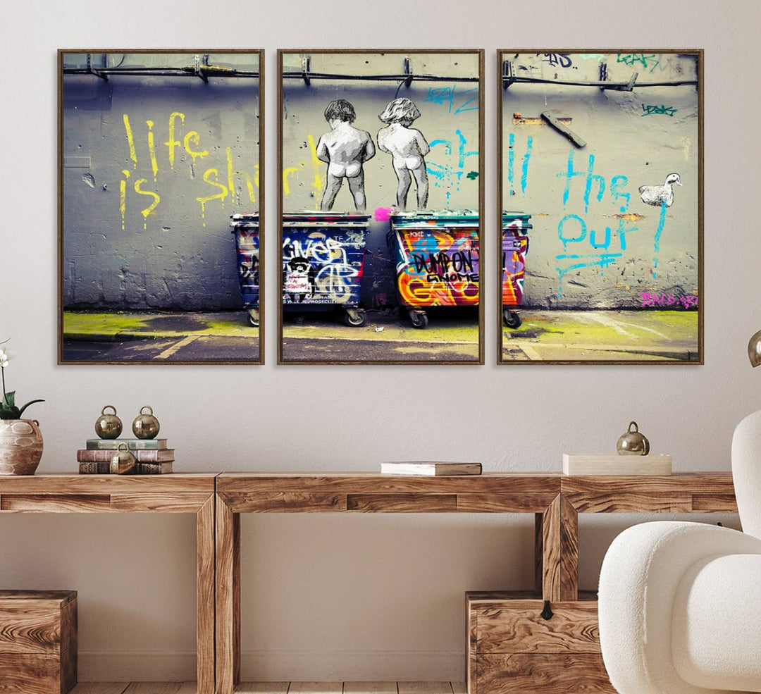 Banksys Life is Short graffiti, featuring kids and text, decorates the wall as a striking piece of framed canvas art.