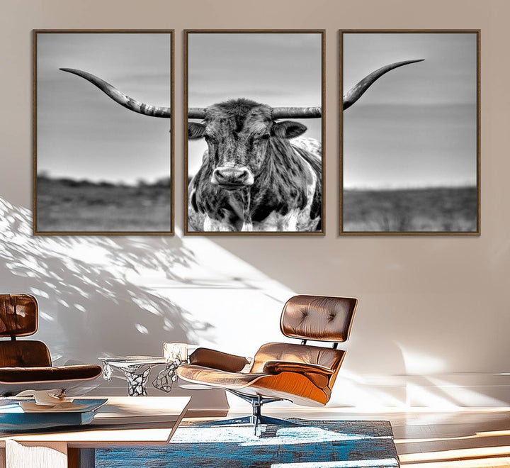 The Texas Longhorn Cow wall art, divided into three panels, is of gallery quality and displayed on a dark wall.