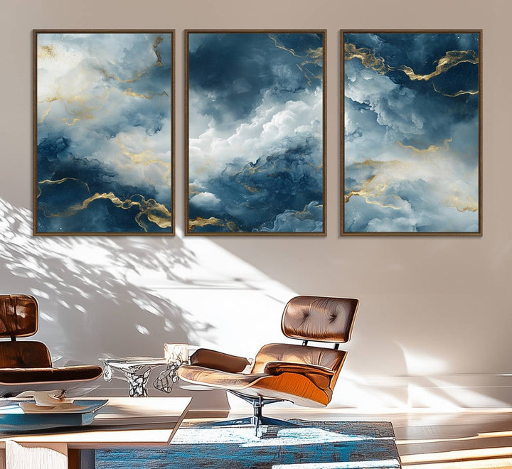 The "Large Abstract Print - Luxe Blue and Gold Abstract Canvas Wall Art" features a bold cloudscape design with swirling white patterns, ideal for modern home decor in living rooms or offices.