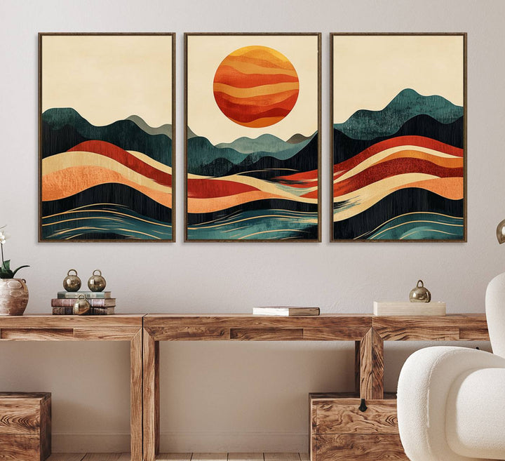 The Mountain Triptych wall art, featuring a design of the sun, mountains, and waves, is displayed prominently on the wall.