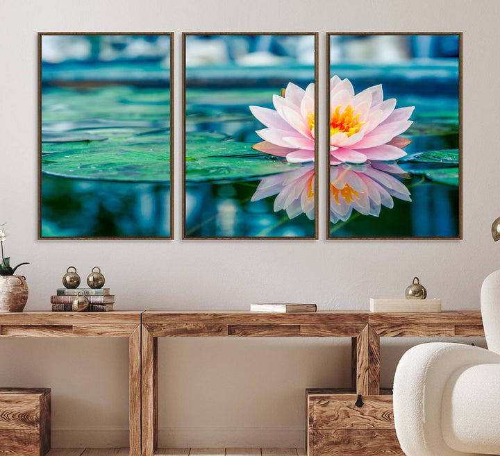 The Lotus Flower Canvas Print showcases a pink water lily with a yellow center gracefully floating on a calm pond.