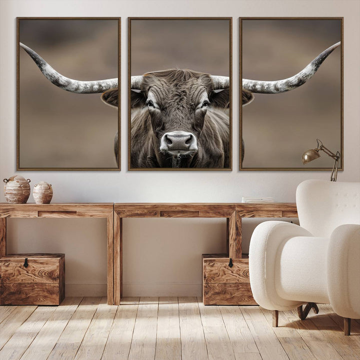 A close-up of a longhorn bull facing forward is featured in the Framed Texas Test-1, set against a blurred brown background.