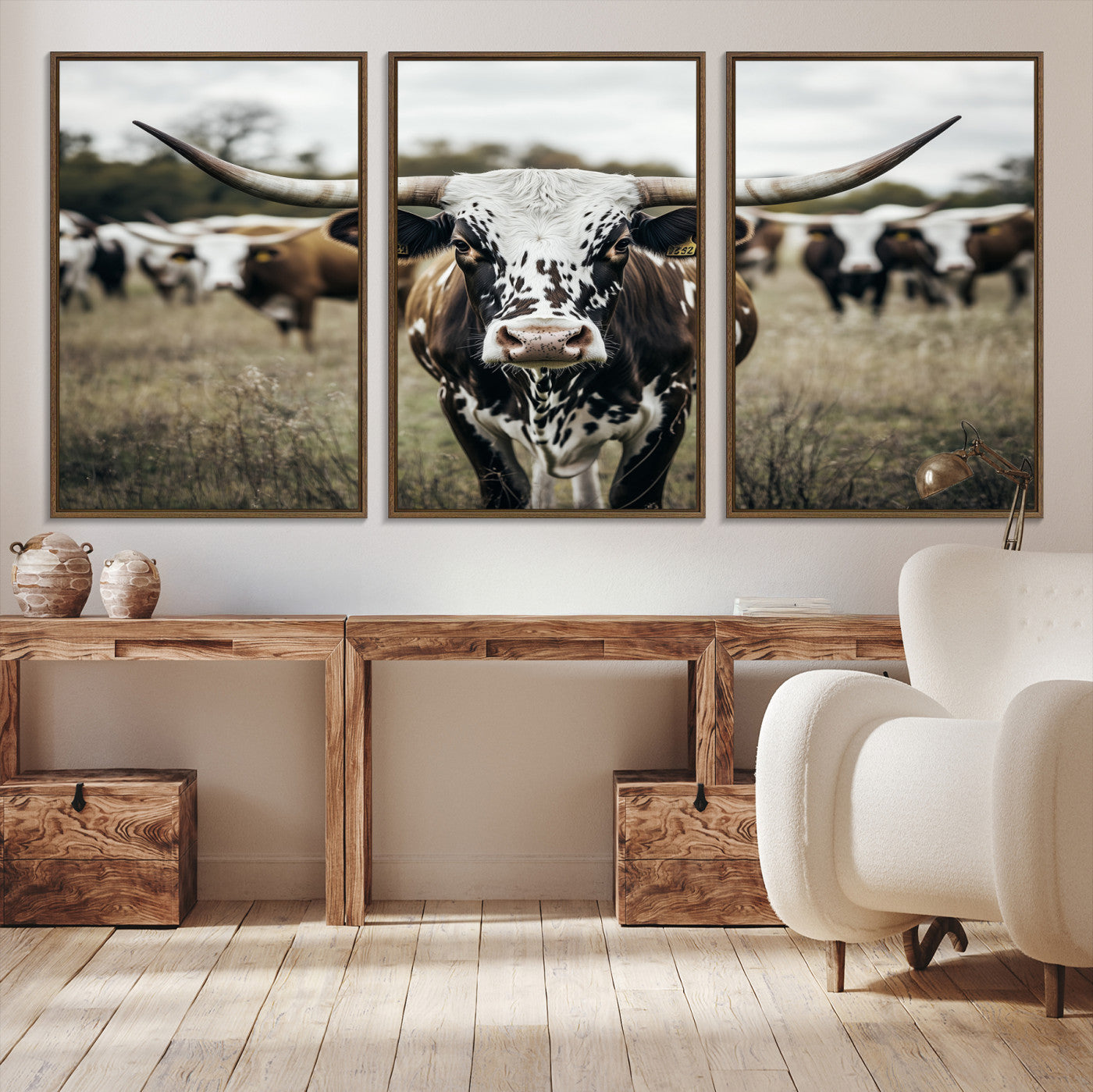 Canvas of a speckled Texas longhorn standing boldly in a field with a herd behind, perfect for rustic western or farmhouse wall decor.