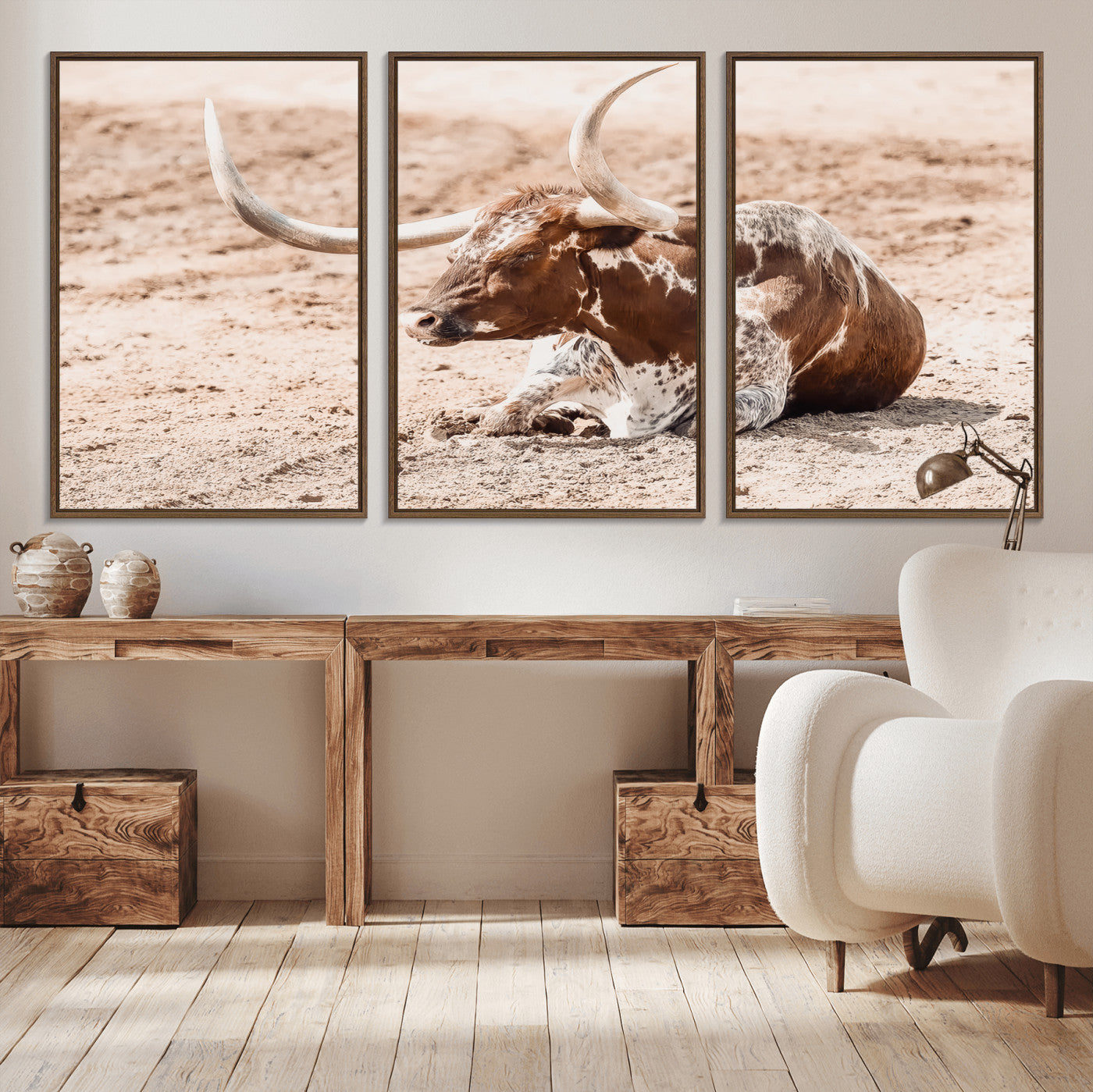 Texas Longhorn bull resting on dusty ground with warm tones, ideal for rustic western or farmhouse-themed wall decor.