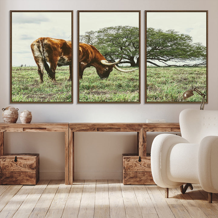 A Texas Longhorn grazing in a green pasture with a large tree in the background, evoking a rustic Western and farmhouse aesthetic.