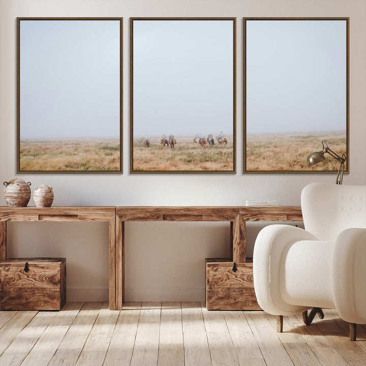 A group of horseback riders moving through a fog-shrouded field, evoking a calm Western scene with golden grasses and soft horizons.