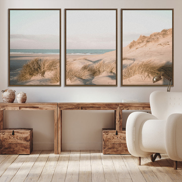 Soft pastel-toned beach scene with sand dunes, windswept grasses, and a calm ocean horizon, creating a serene coastal atmosphere.