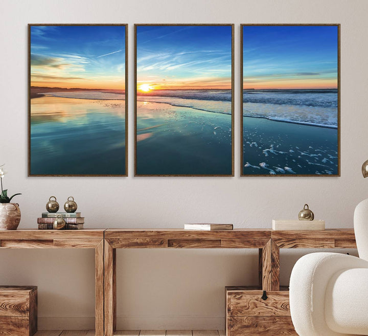 The Blue Sky and Beach Wall Art Canvas Print features a vibrant orange sky reflecting on wet sand.