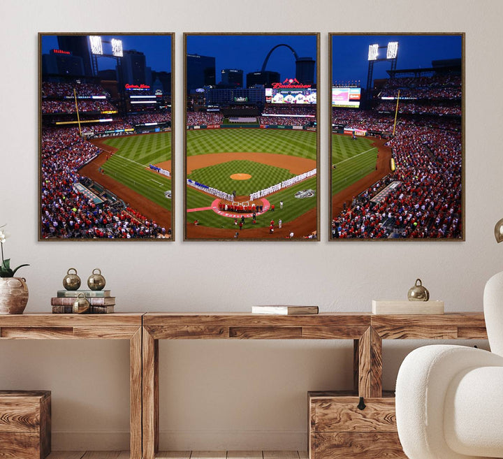 A Cardinals wall art canvas print depicts Busch Stadium with players lined up on the field and a full audience under the lights, capturing the vibrant atmosphere.