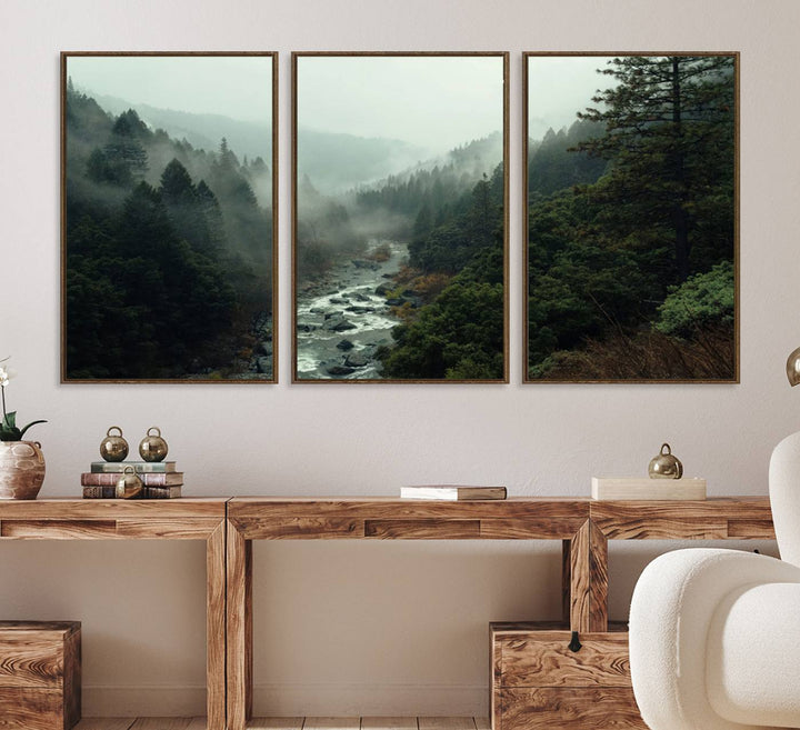 The Misty Forest Wall Art features a serene landscape with a misty river and evergreens, ideal for enhancing the ambiance of any living room or cabin.