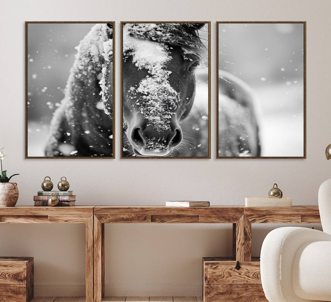 The Black and White Horse Winter Wall Art features a majestic horse with snow-covered hair set against a serene winter backdrop.