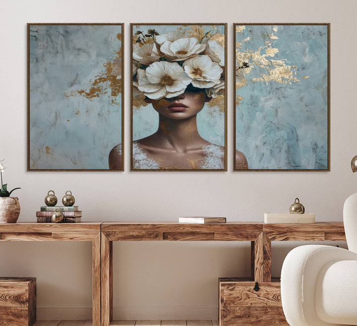 Golden Petal Wall Art: A womans face adorned with a gold floral design on a teal background, presented in a 3-panel modern glam canvas.