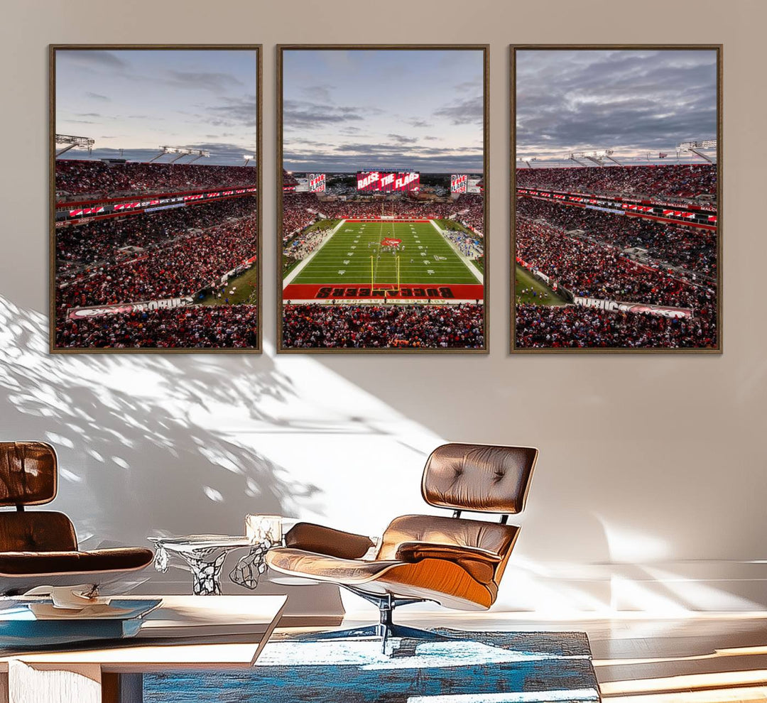 The wall art captures a stunning scene of Raymond James Stadium bathed in the warm hues of sunset. The sky, filled with clouds, provides a dramatic contrast to the vibrant lighting on the field, encapsulating the dynamic energy of a football game.