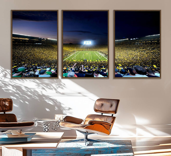 The wall art features a glowing M in this Michigan Wolverines Football Team Ann Arbor Stadium Canvas Print.