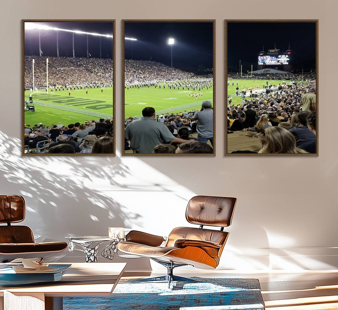 A painting depicting the Purdue Boilermakers football game at Ross-Ade Stadium is illuminated under gallery-quality lights.