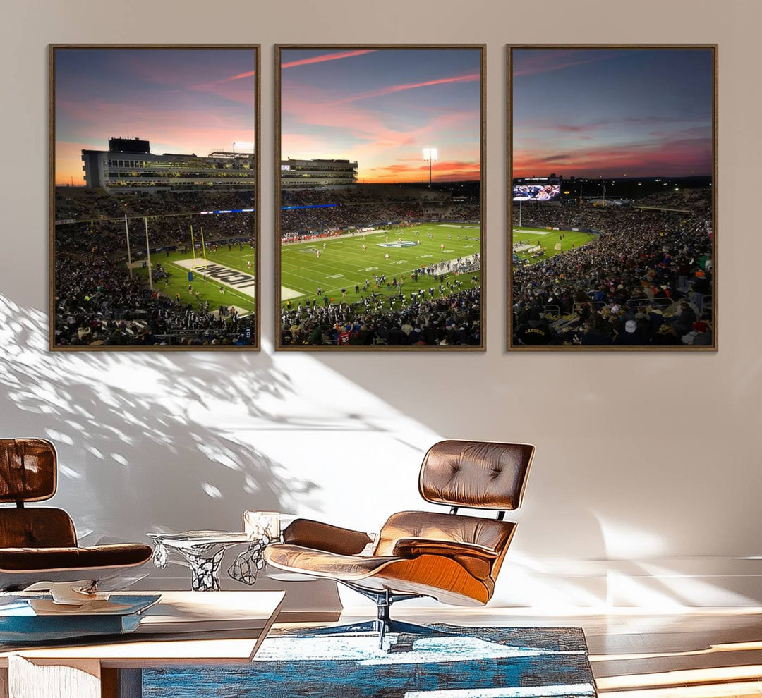 This wall art canvas print captures UCONN Huskies fans energizing a sunset scene at East Hartfords Pratt & Whitney Stadium.