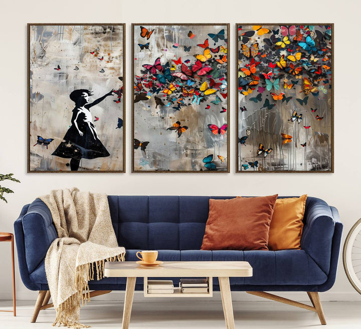 The Banksy Butterfly Girl 3-Piece Modern Graffiti Canvas Wall Art features a silhouette of a girl reaching for butterflies.