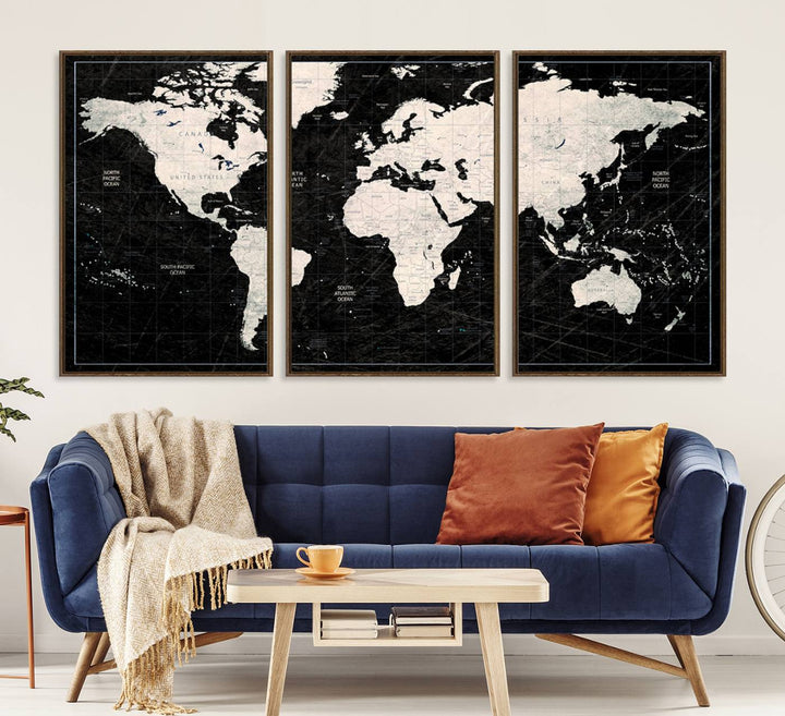 A bold global style framed black and white world map canvas print, presented in three panels, perfect for modern home or office decor.