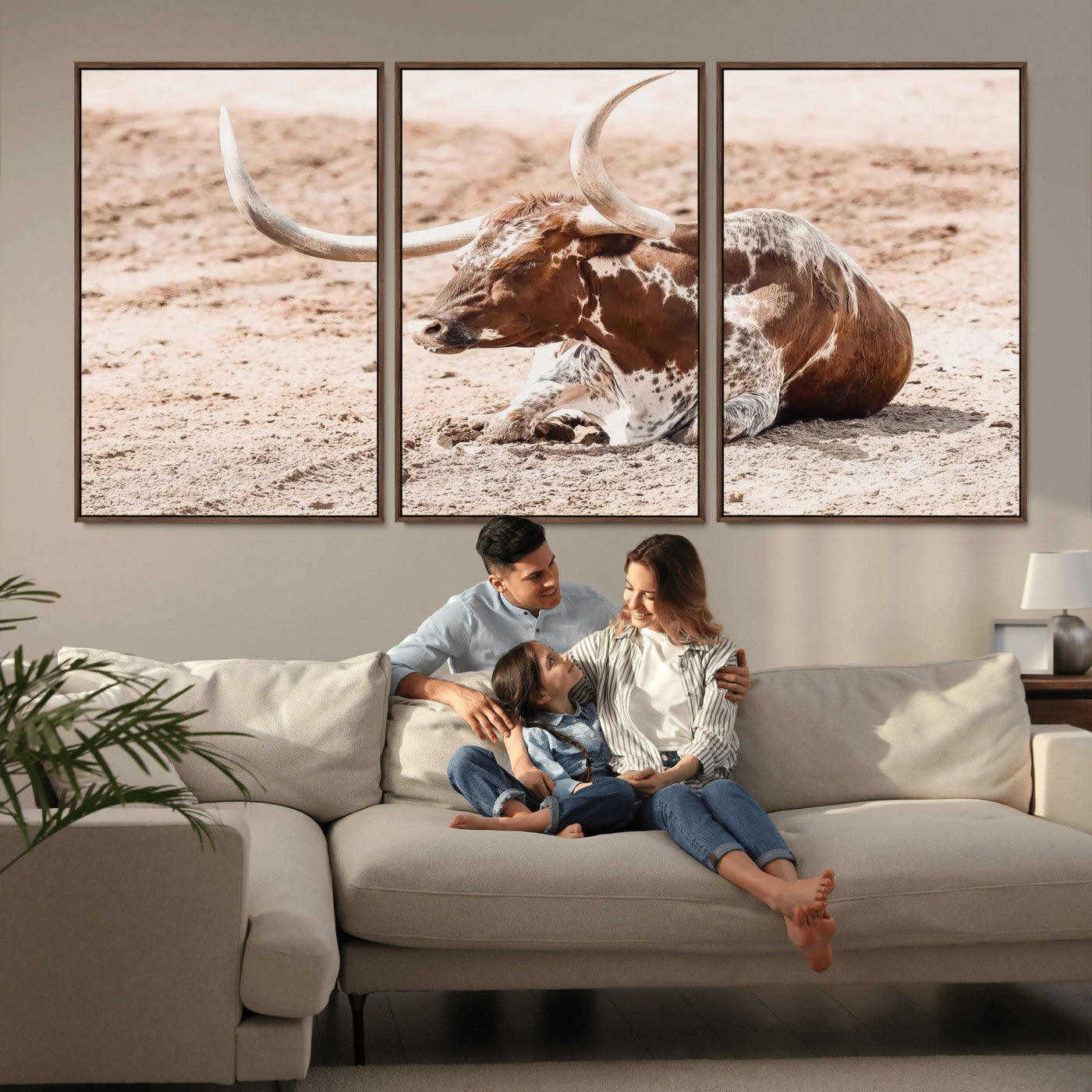 Texas Longhorn bull resting on dusty ground with warm tones, ideal for rustic western or farmhouse-themed wall decor.