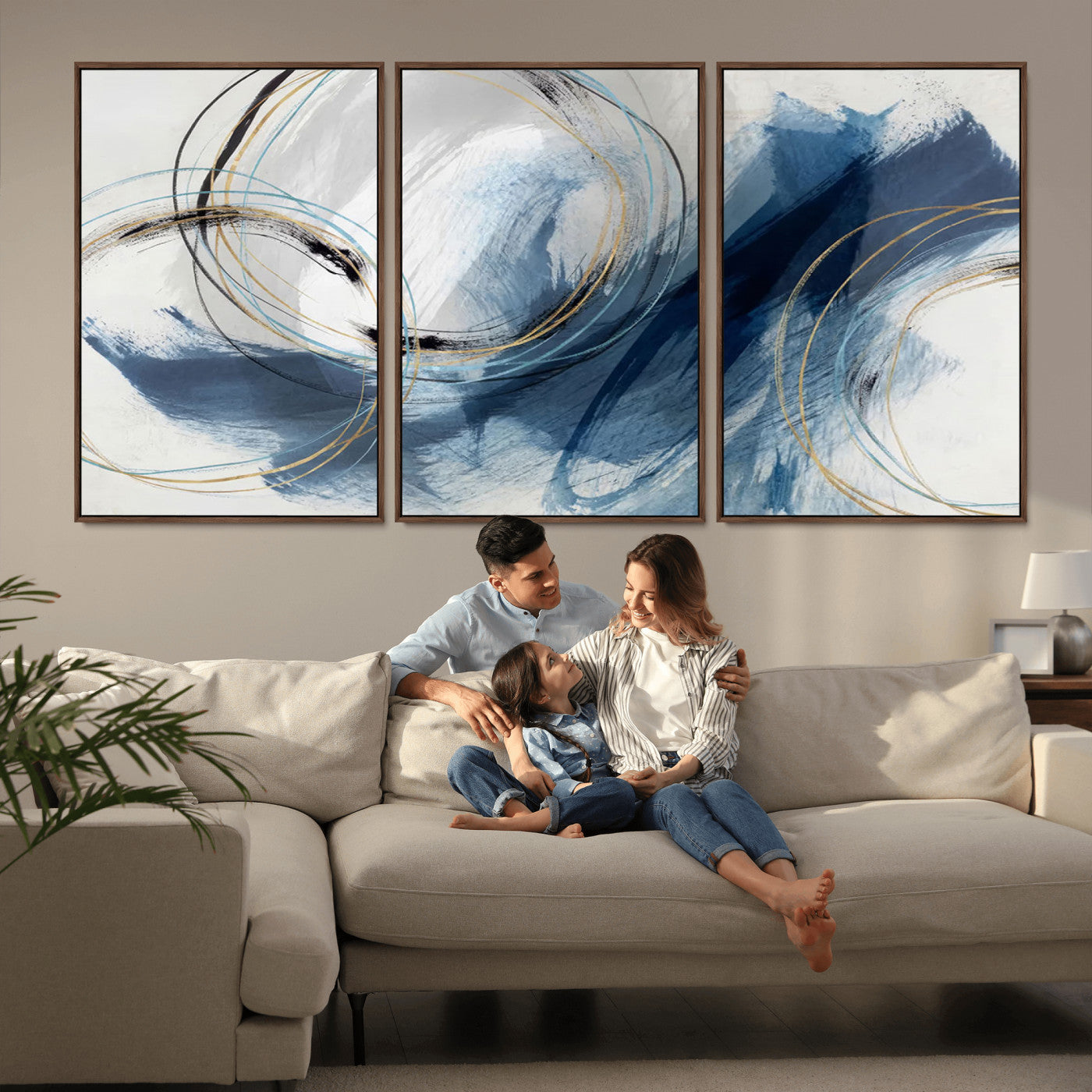 Abstract wall art featuring dynamic brush strokes in shades of blue and gray, overlaid with delicate circular line patterns in gold, black, and light blue on a white background.
