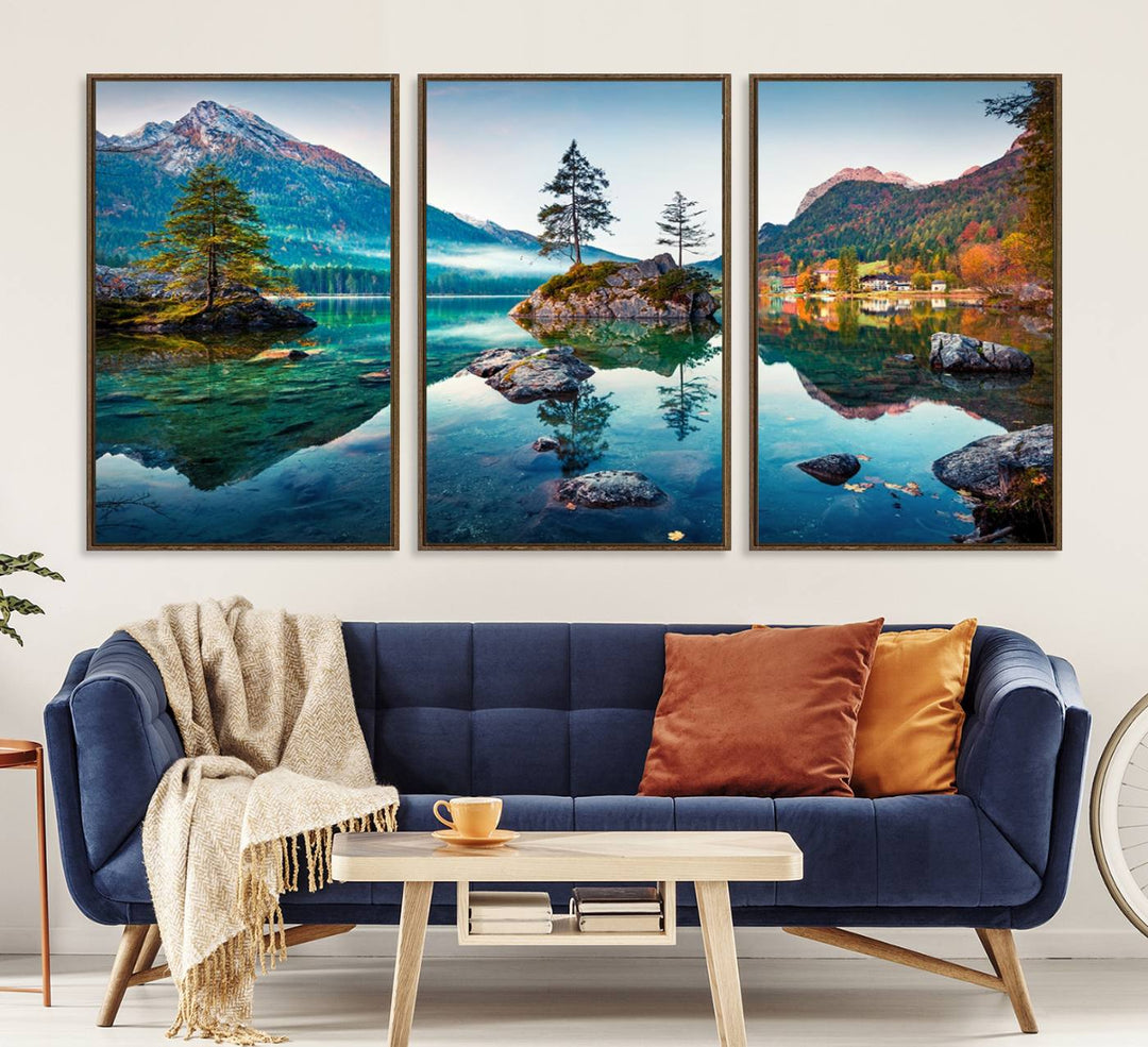 The 3-panel wall art showcases a serene mountain lake with rocky islands and trees, creating an ideal focal point for dining rooms or offices.