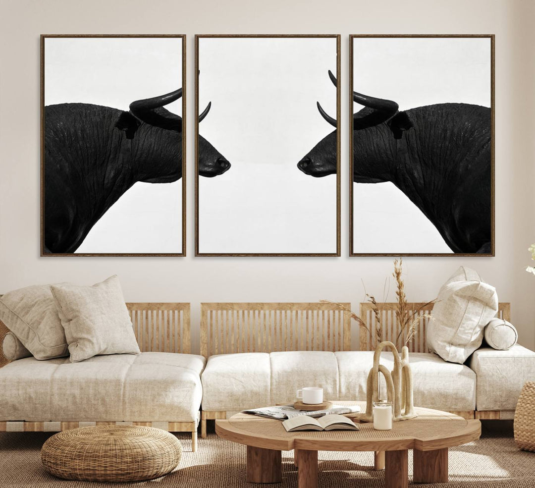 A framed canvas print featuring two black bull silhouettes, perfect for modern rustic decor.