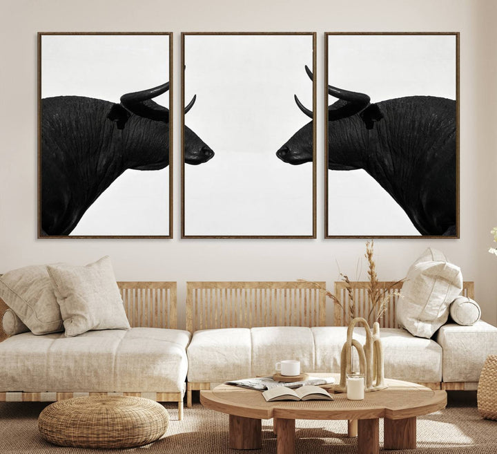 A framed canvas print featuring two black bull silhouettes, perfect for modern rustic decor.