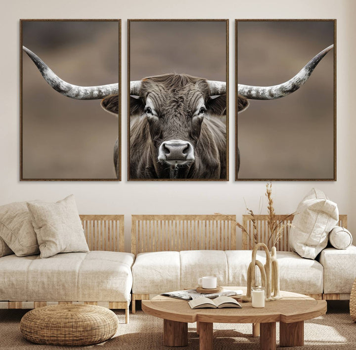 A close-up of a longhorn bull facing forward is featured in the Framed Texas Test-1, set against a blurred brown background.