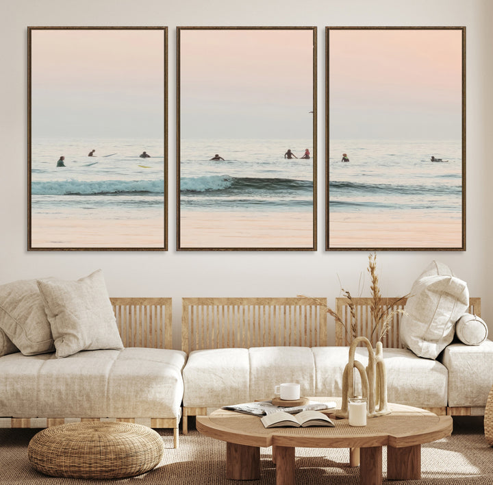 Dreamy photo of surfers waiting on soft pastel waves under a pink sunset sky, ideal for soft coastal minimalist or serene ocean-themed home decor.