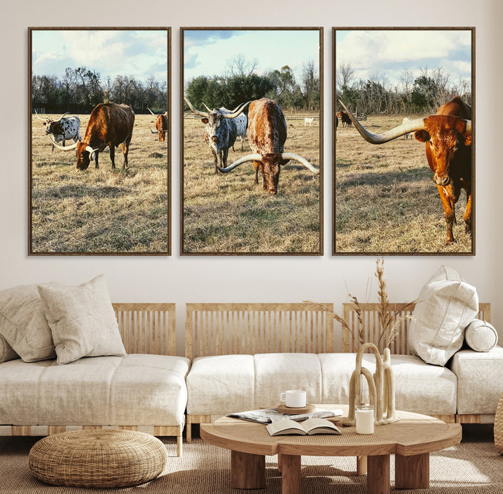 A herd of Texas Longhorn cattle grazing in an open field under a partly cloudy sky, capturing a rustic and Western ranch aesthetic.