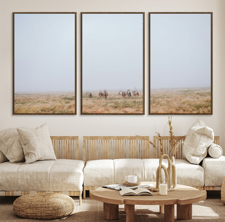 A group of horseback riders moving through a fog-shrouded field, evoking a calm Western scene with golden grasses and soft horizons.