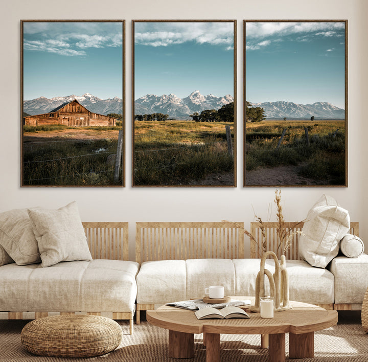 A rustic farmhouse with a wooden barn set against majestic mountain peaks under a soft blue sky, evoking peaceful countryside charm.