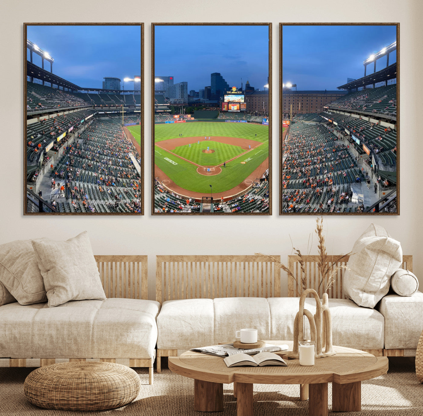 Wide panoramic view of a baseball stadium at dusk with players on the field, stadium lights illuminating the scene, and a sparse crowd of spectators in the stands.