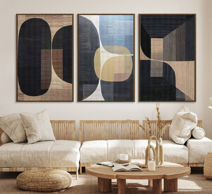 Abstract geometric wall art featuring black, gray, beige, and blue tones framed in a wooden border.