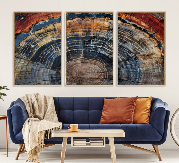 The Abstract Tree Ring Wall Art in orange, blue, and gray perfectly complements minimalist nature-inspired home decor.