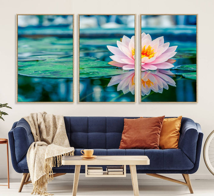 The Lotus Flower Canvas Print showcases a pink water lily with a yellow center gracefully floating on a calm pond.